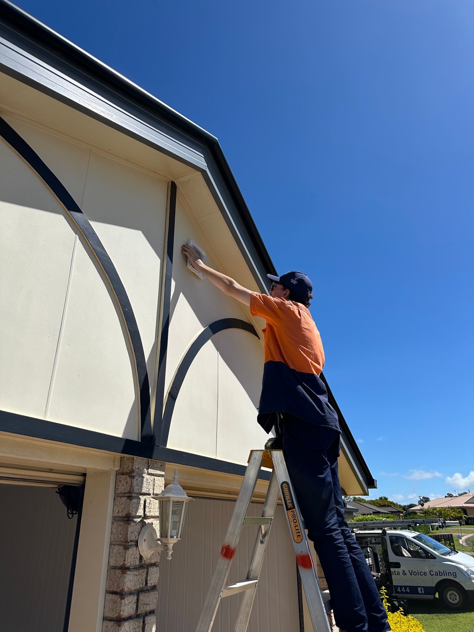 A Siren Panel Being Mounted On The Side Of A Building - Security Company in Toowoomba, QLD