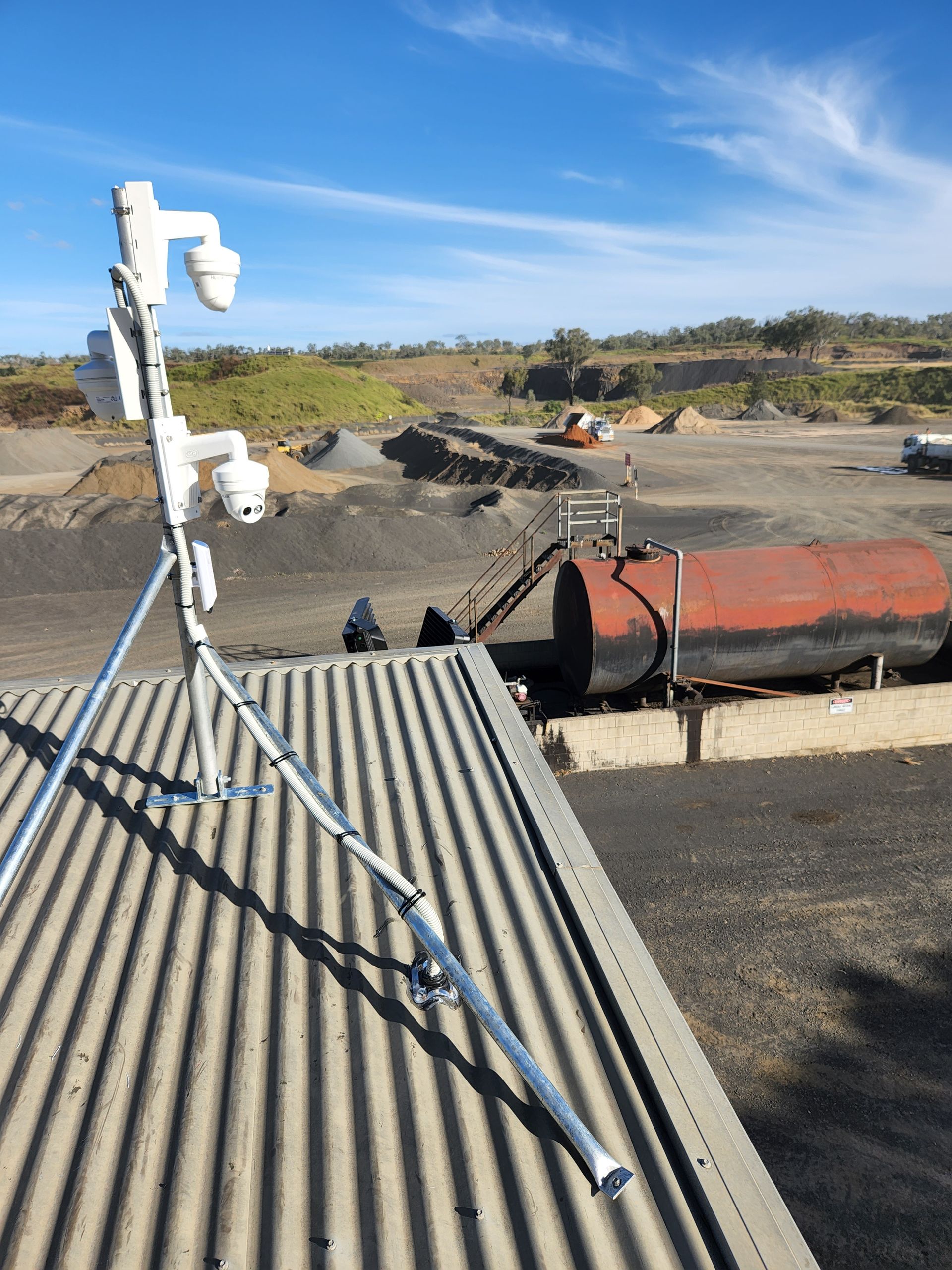 Security Cameras Mounted on a Tripod Atop a Corrugated Metal Roof — Frontier Security in Warwick, QLD 