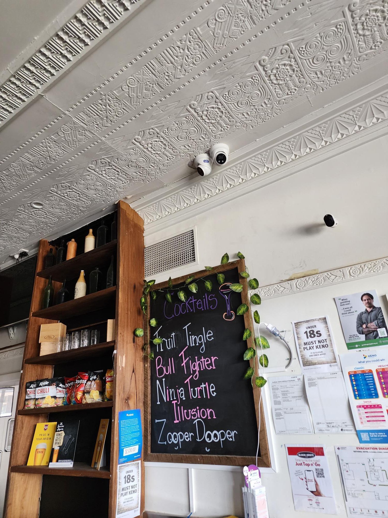 A Cafe With a Menu Board, Shelves of Items, and Security Cameras on the Ceiling — Frontier Security in Gatton, QLD