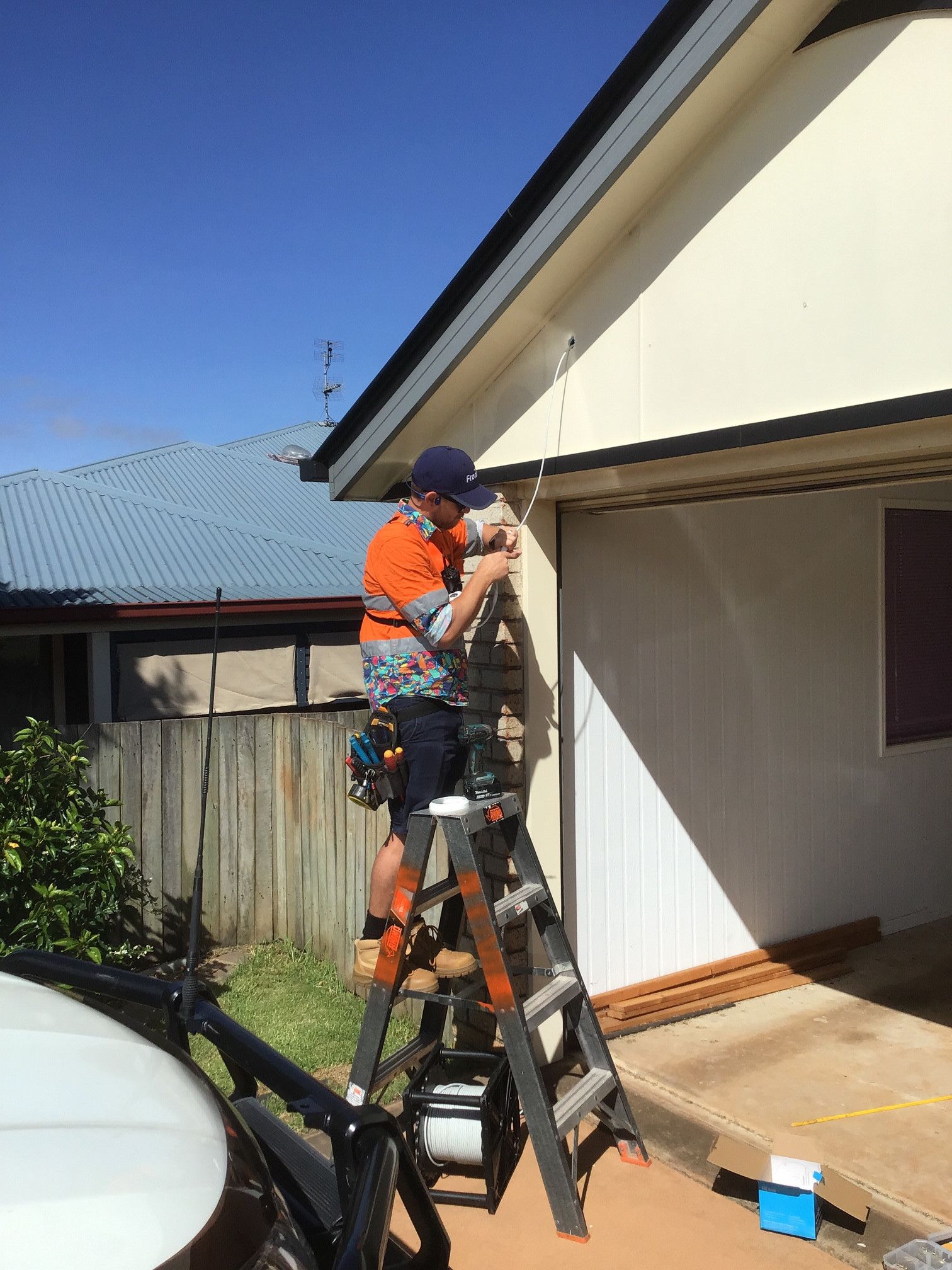 Person on Ladder Works on Building Exterior, Outdoors in Daylight — Frontier Security in Dalby, QLD