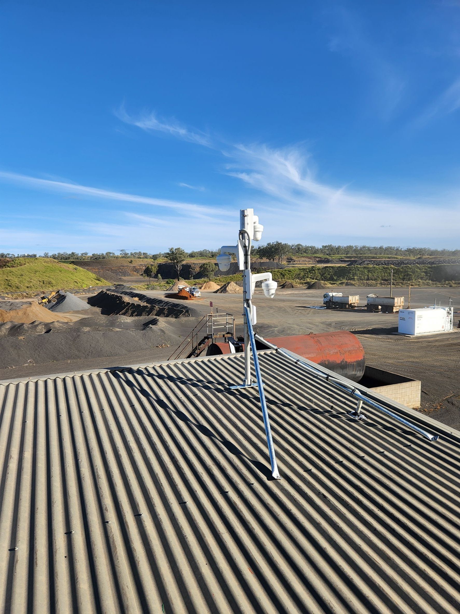 Antenna Array on a Corrugated Metal Roof Against a Bright Blue Sky With Sparse Clouds — Frontier Security in Warwick, QLD 