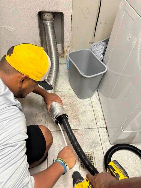 A close up of a dirty air vent on a ceiling.
