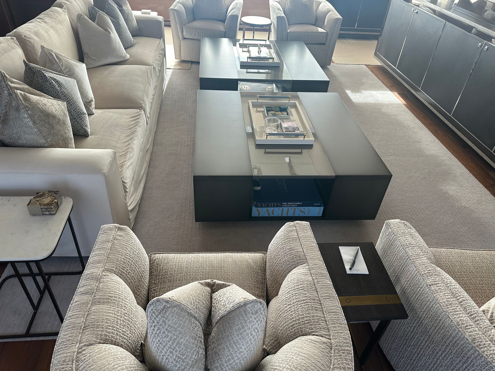 A large yacht is docked in the water at sunset.