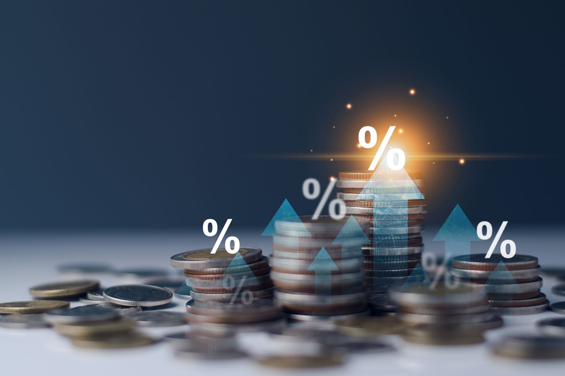 Stacks of coins with rising percent symbols and an upward arrow, symbolizing finance or growth