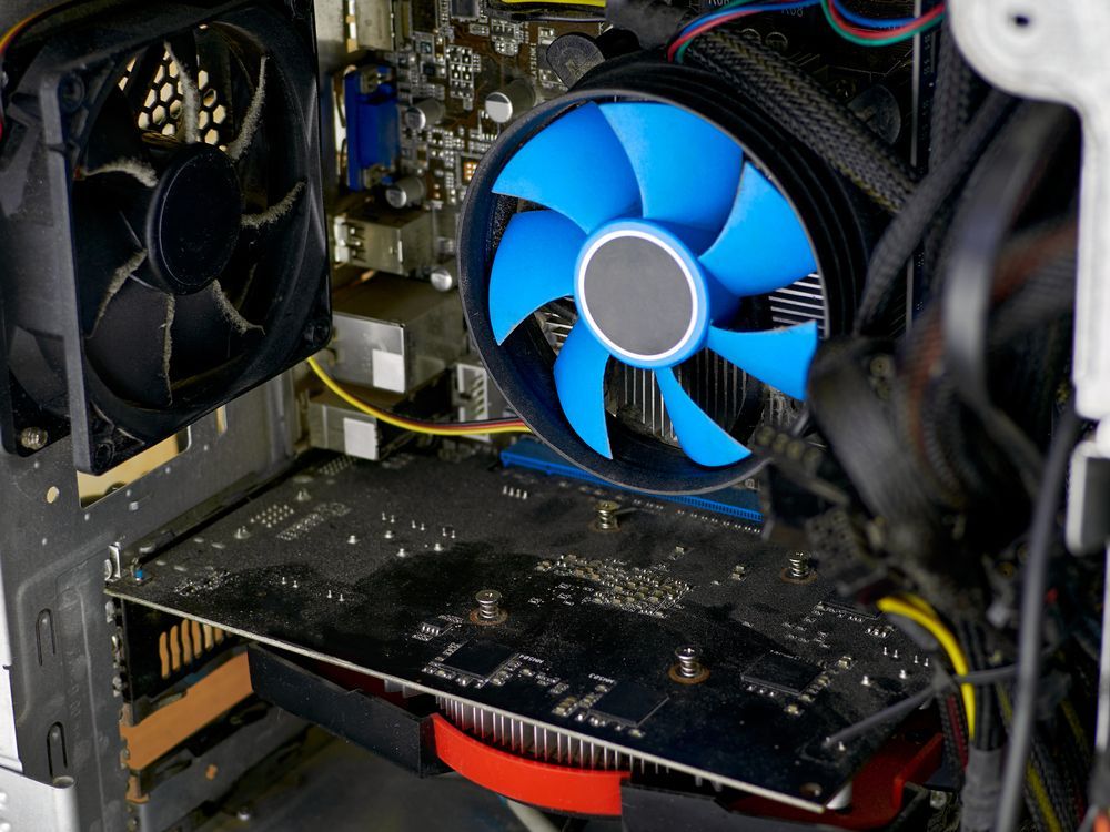 Computer interior with black and blue fans, a graphics card, and wires.