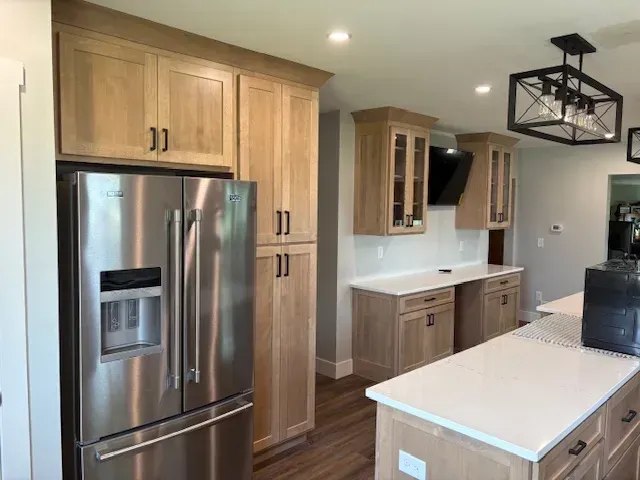 Kitchen remodel with custom cabinetry and stainless refrigerator in Dubuque, IA