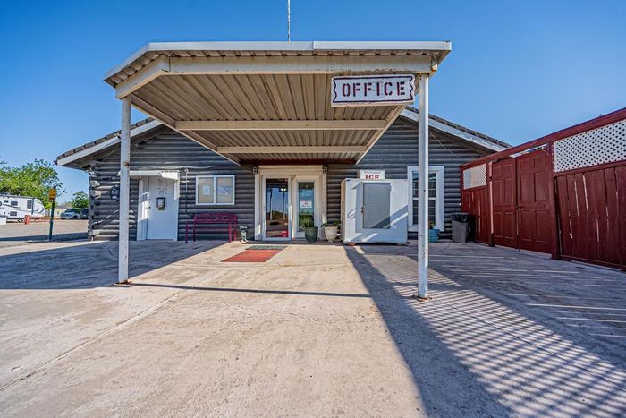 The front of a small building with office sign