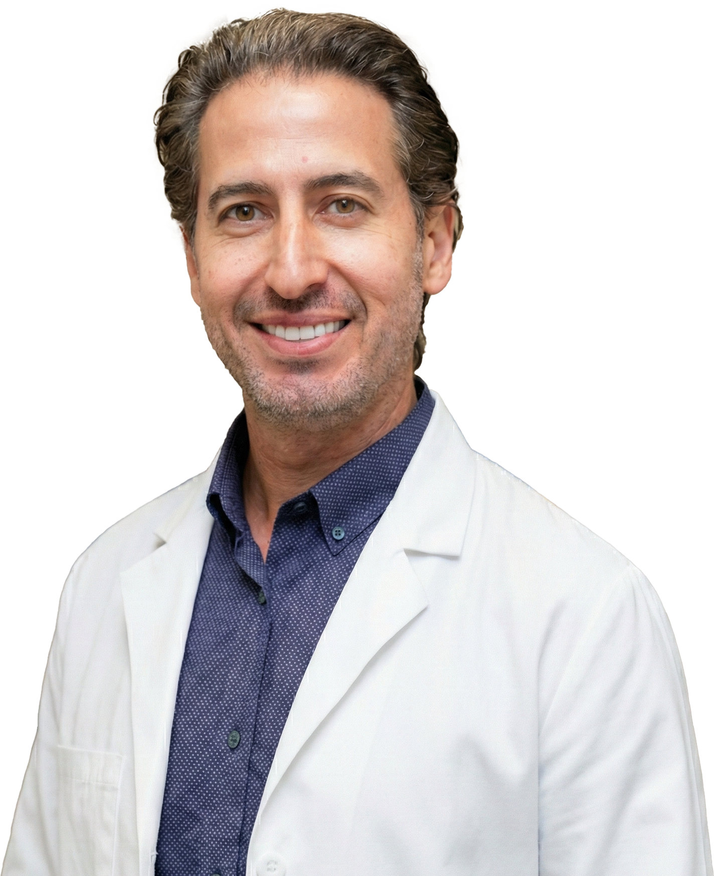 Smiling man in a white coat, blue patterned shirt.