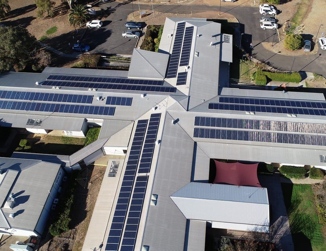An Aerial View Of A Large Building With Solar Panels On The Roof — Max Fox Electrical in Gunnedah, NSW