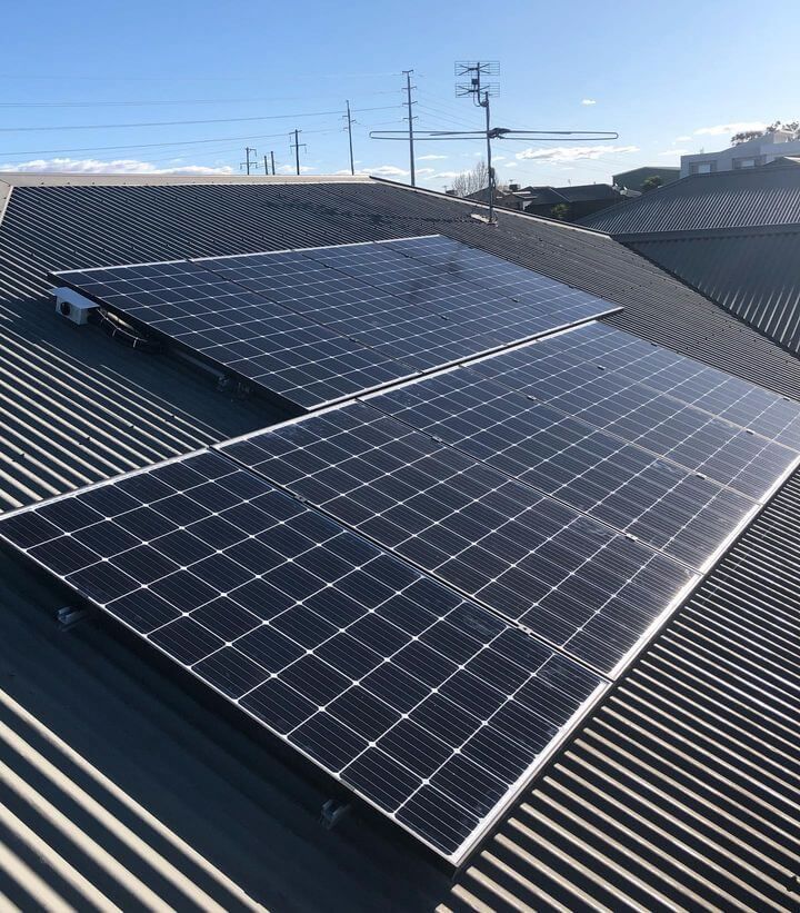 A Row of Solar Panels with a Blue and Clear Sky in Background — Max Fox Electrical in Gunnedah, NSW