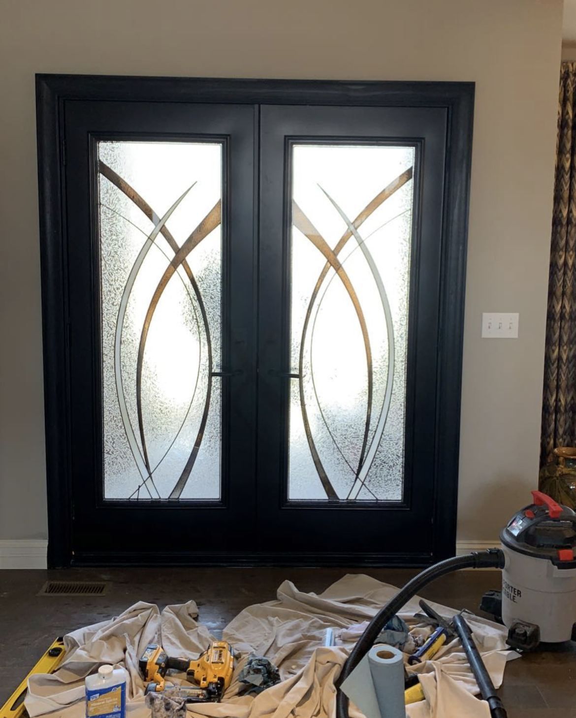Black double entry doors with decorative glass, just installed