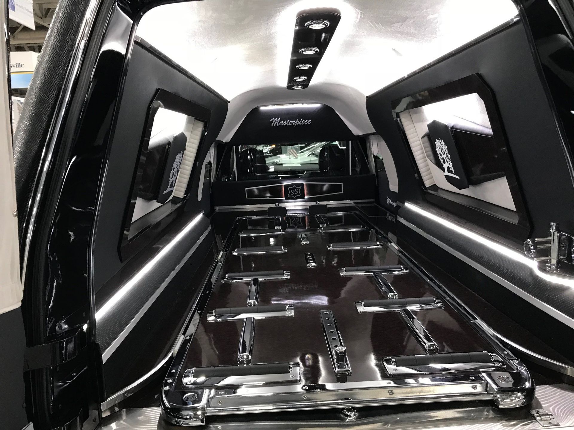 The inside of a funeral vehicle with the doors open