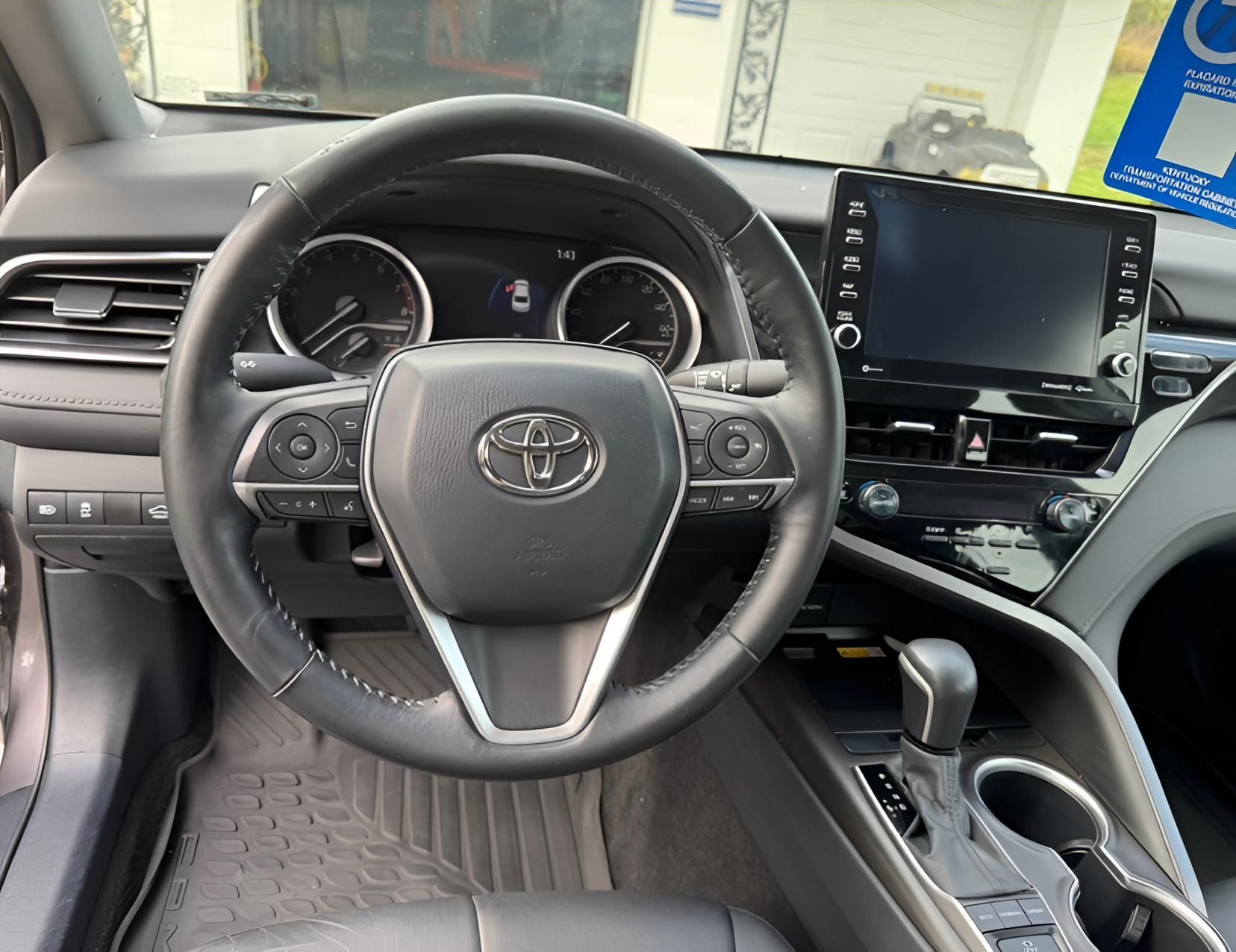 Two photos of a Toyota Camry interior. A steering wheel, dashboard, and center console are visible in each.