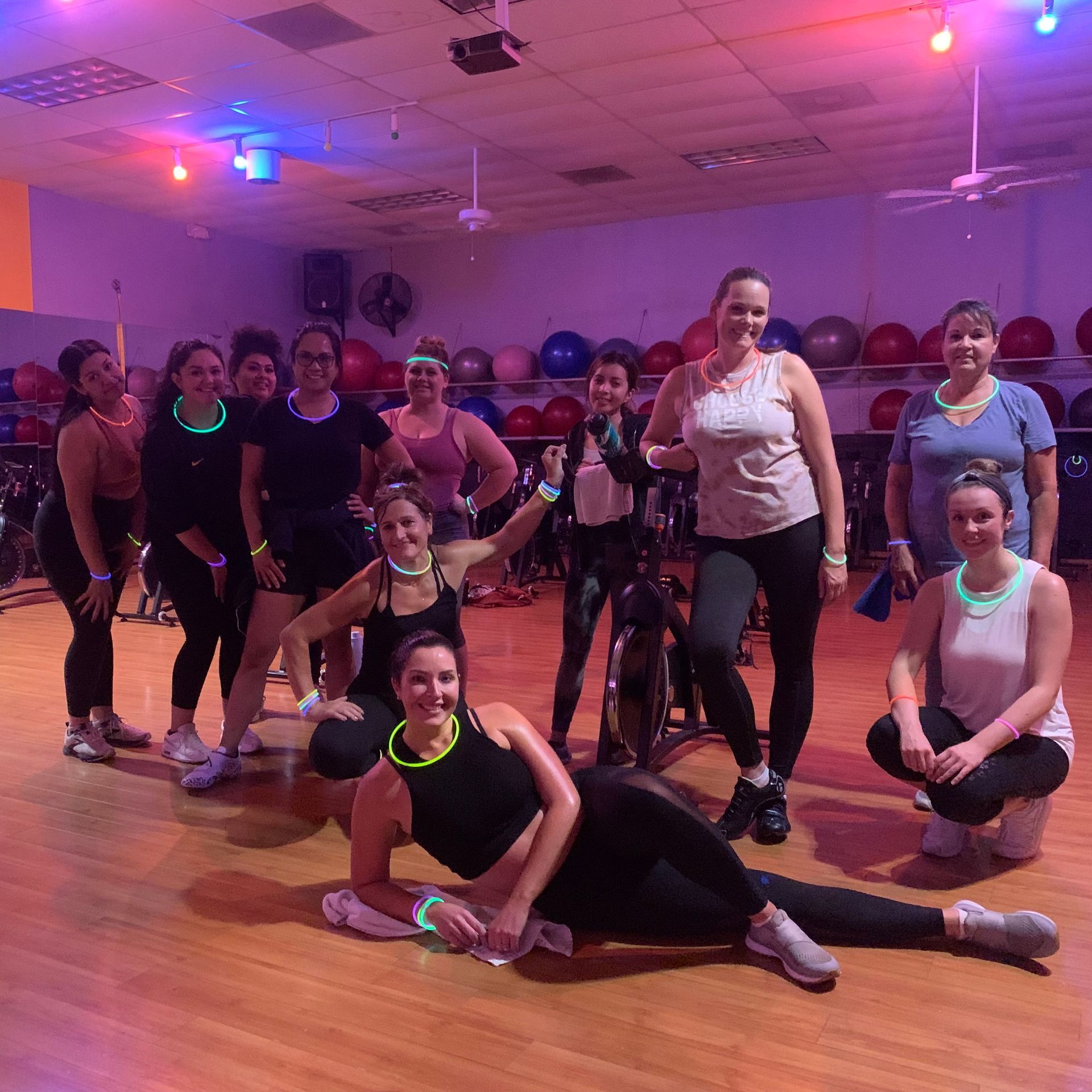 A group of women are posing for a picture in a gym.