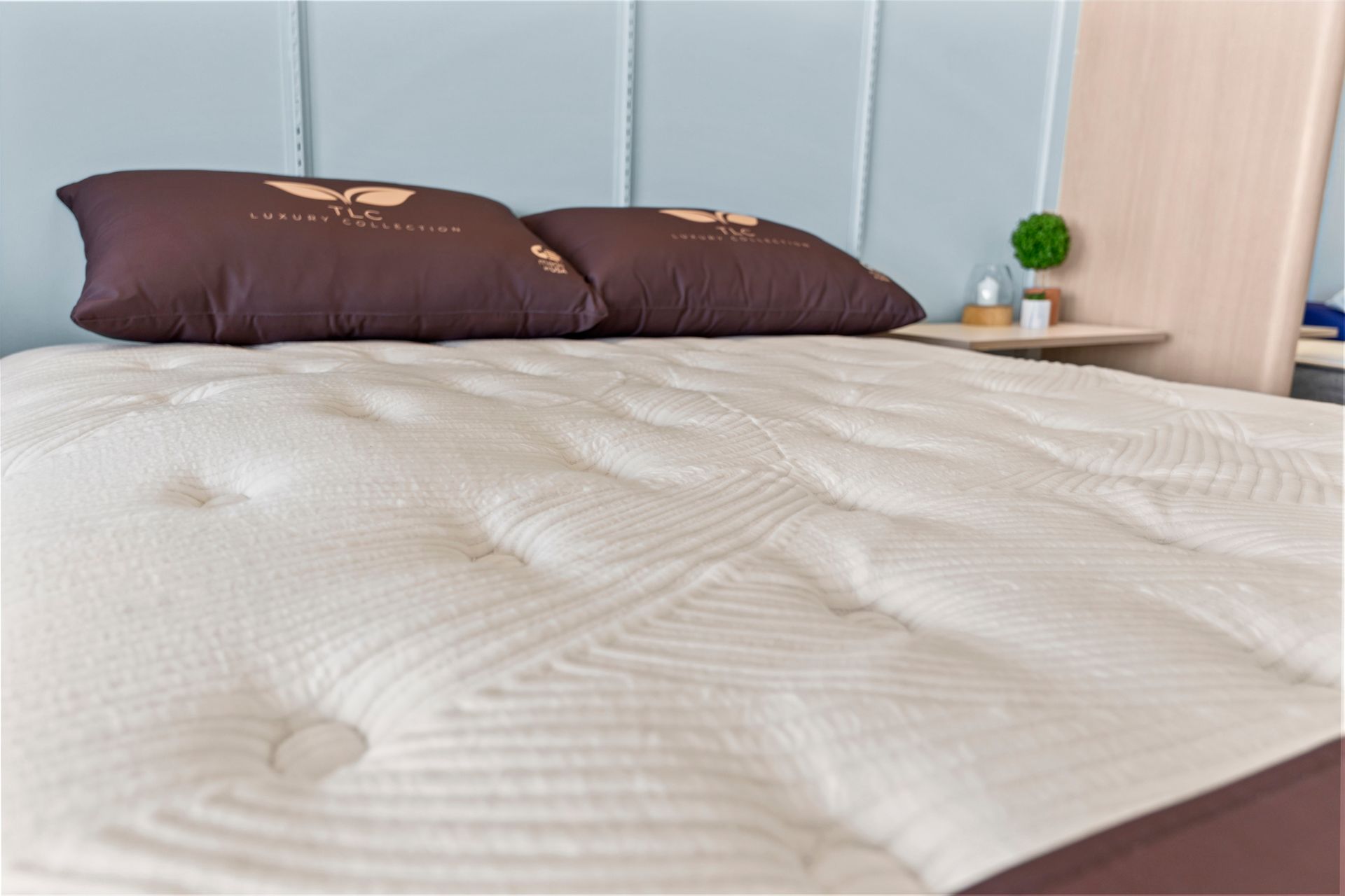 A person 's hand rests on a white mattress