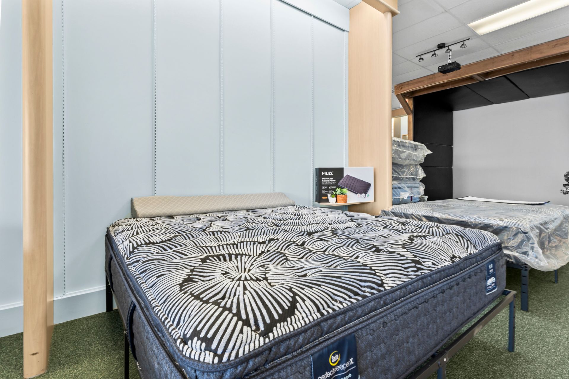 Two mattresses are sitting next to each other in a room.