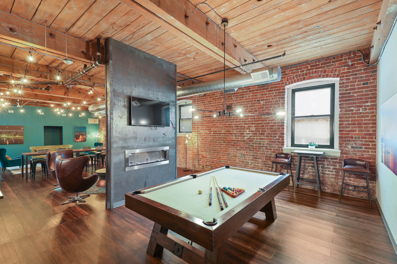 There is a pool table in the middle of the clubhouse.