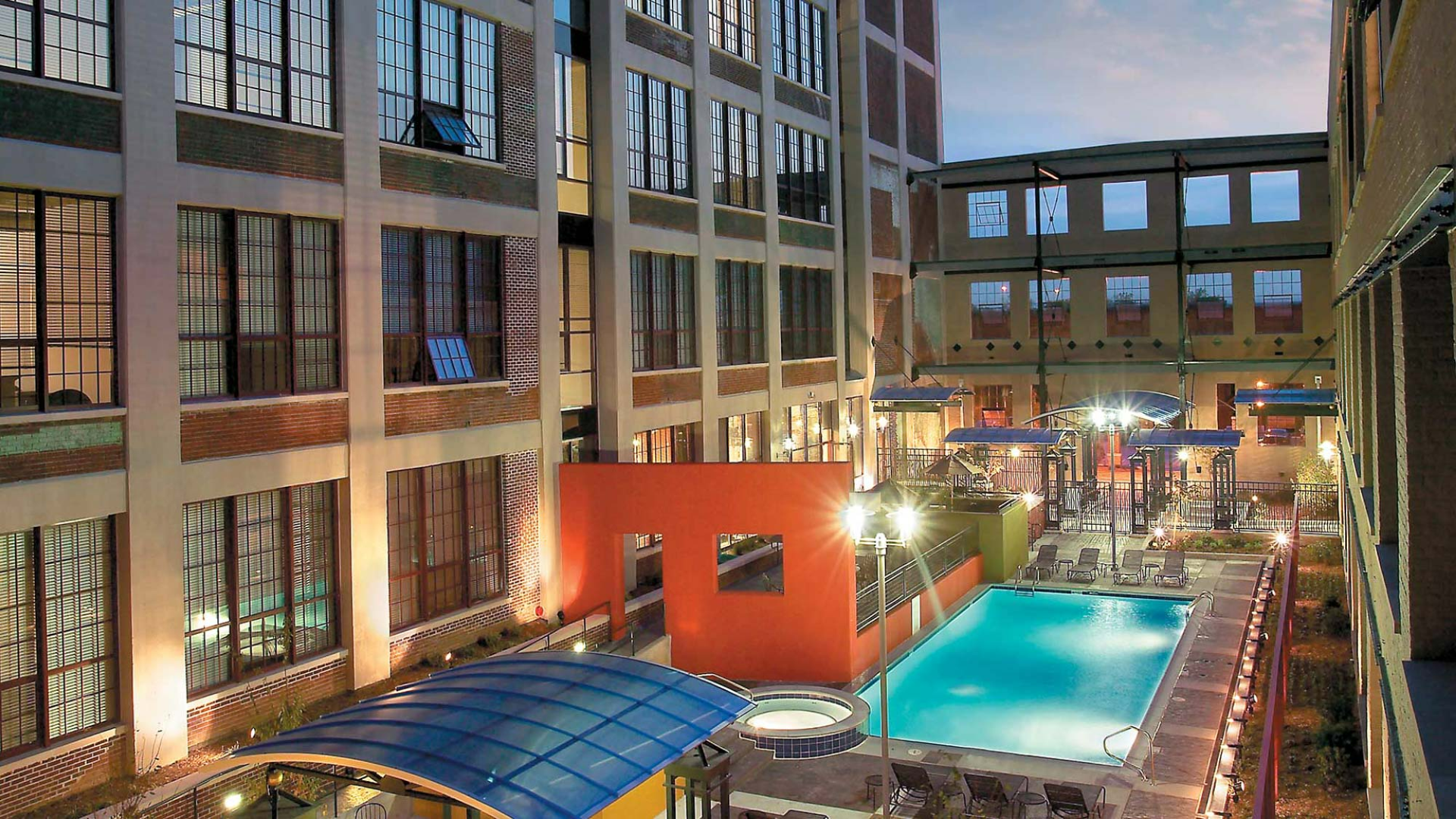 A large building with a swimming pool in the middle of it.