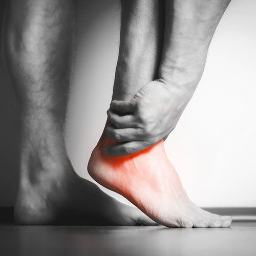 A Person Is Holding His Ankle in Pain — Birdsboro, PA — Fleetwood Foot & Ankle Center A Person Is Holding His Ankle in Pain — Birdsboro, PA — Fleetwood Foot & Ankle Center