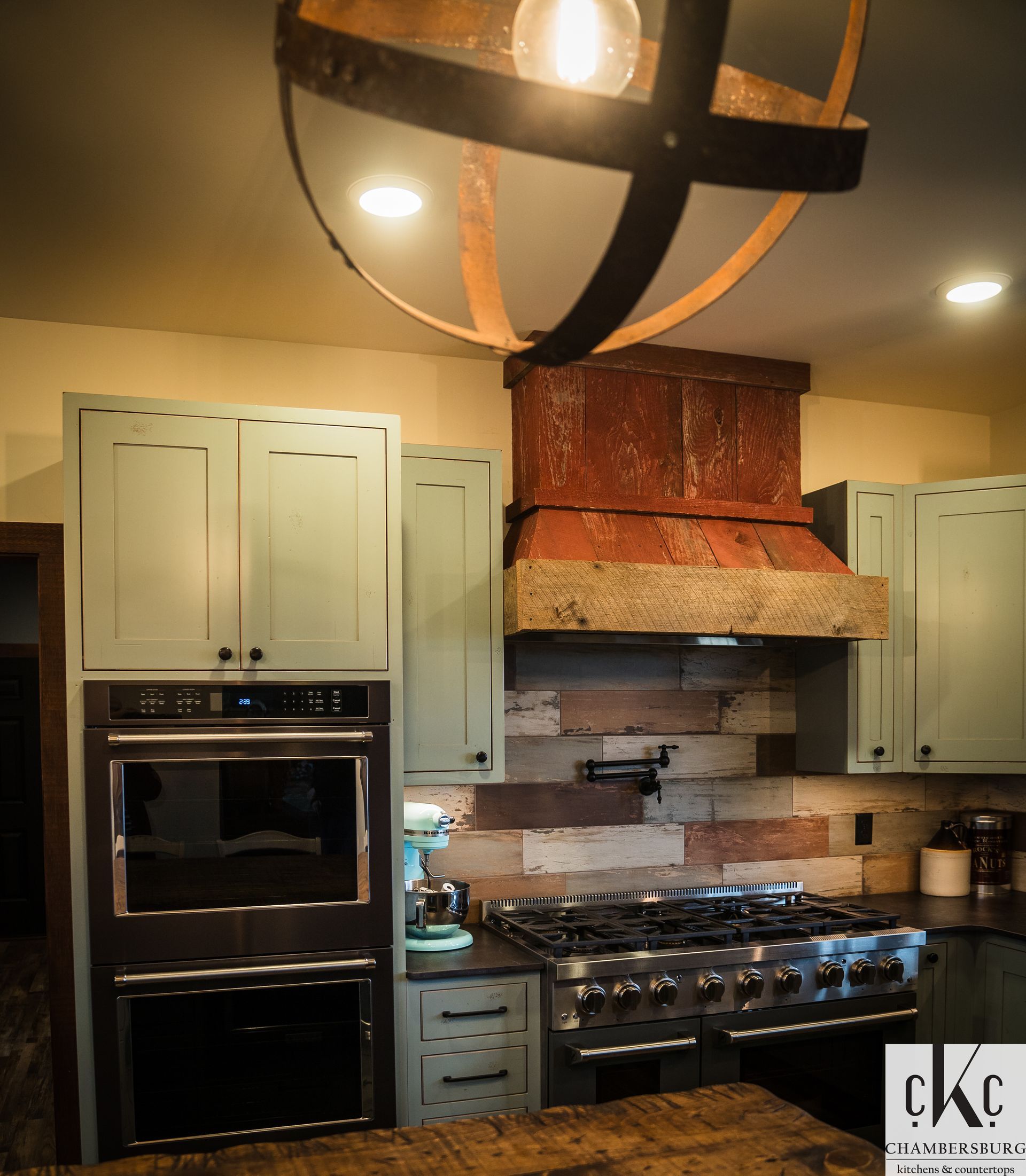 A kitchen with blue cabinets and a stove top oven