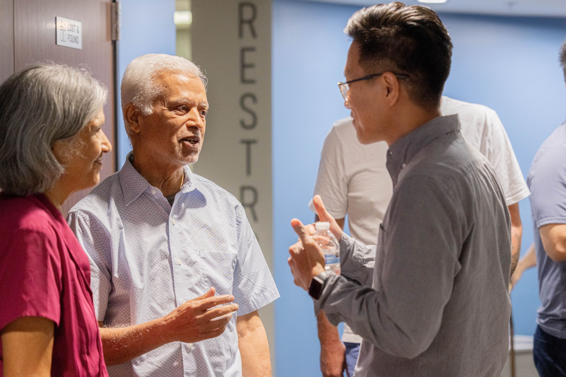 A group of Christians are talking to each other in a room.