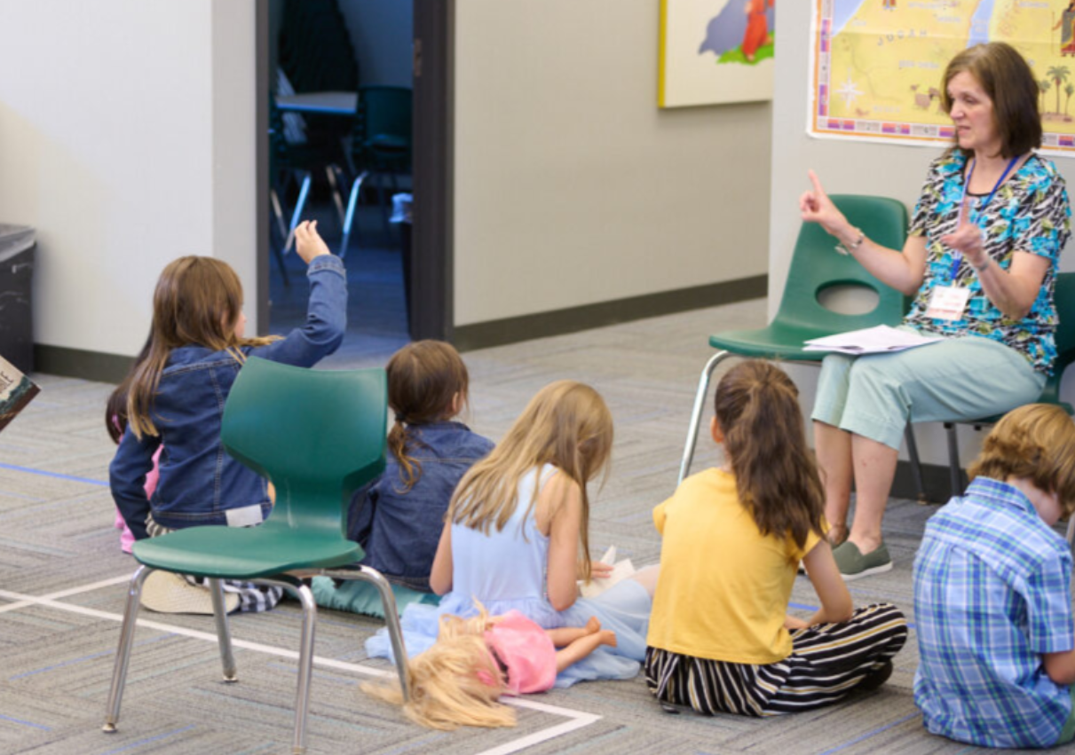 volunteer leading a bible story class for children