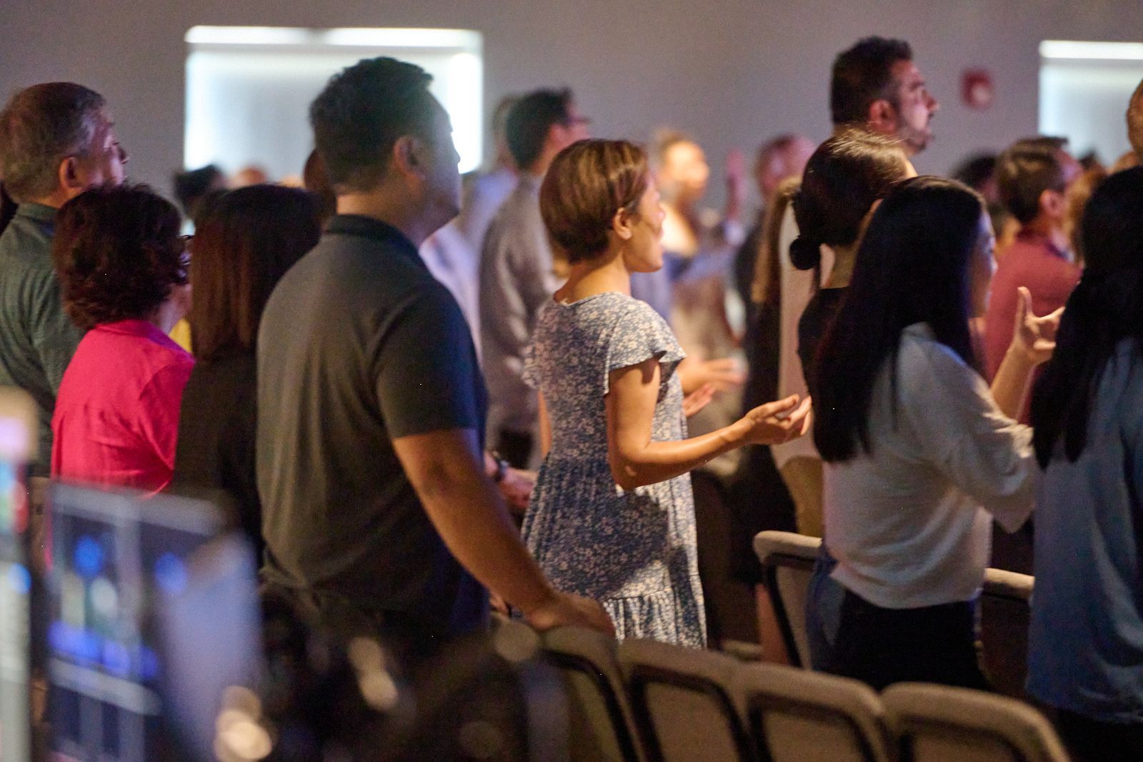 A group of people are standing in a church.