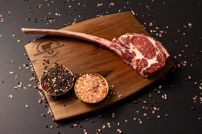 A pile of meat is sitting on a piece of paper on a table. A pile of meat is sitting on a piece of paper on a table.