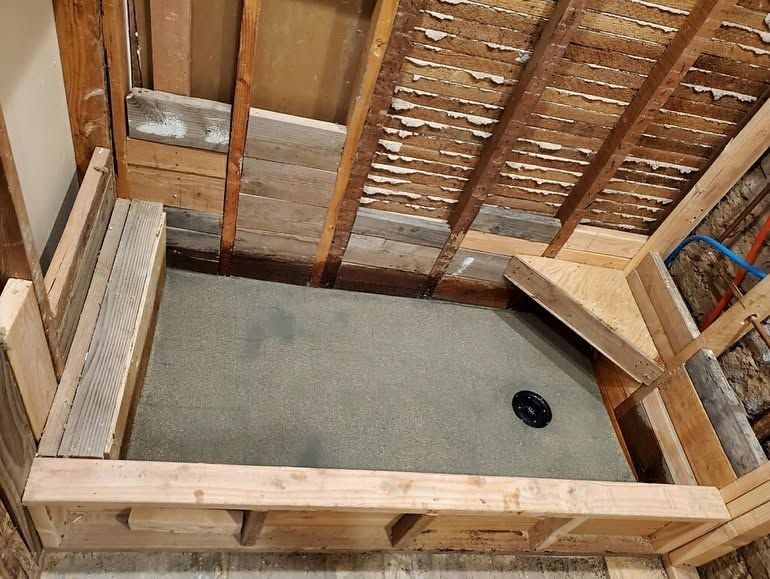 Partially framed room under construction with exposed studs and a concrete floor