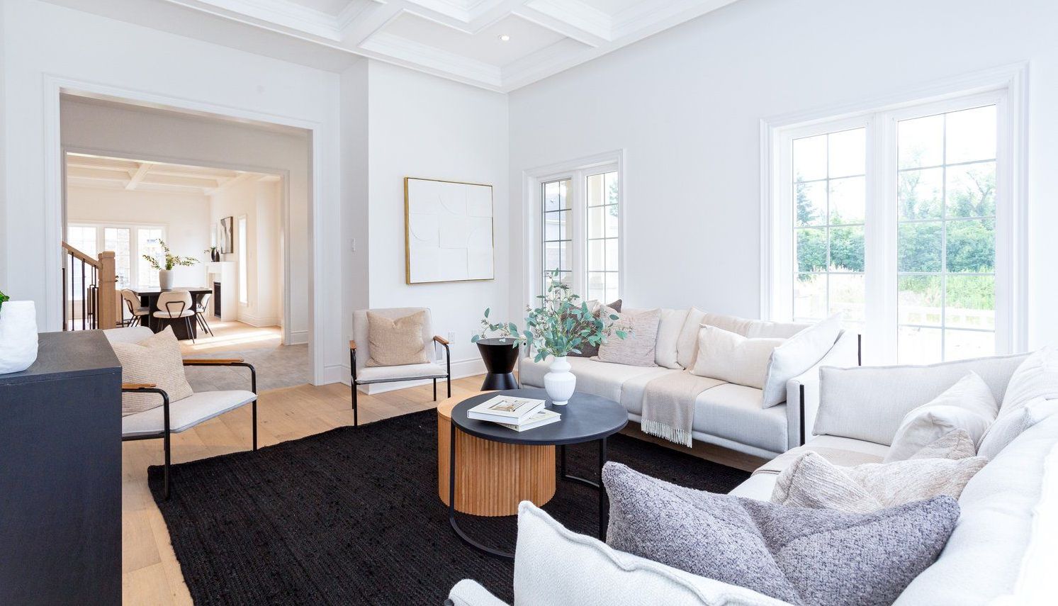 A living room with a couch , chairs , and a coffee table.