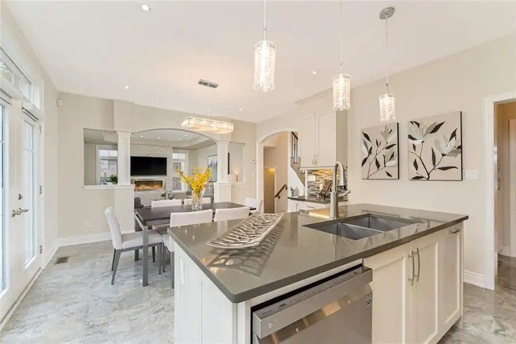 A kitchen with a large island and a stainless steel dishwasher.