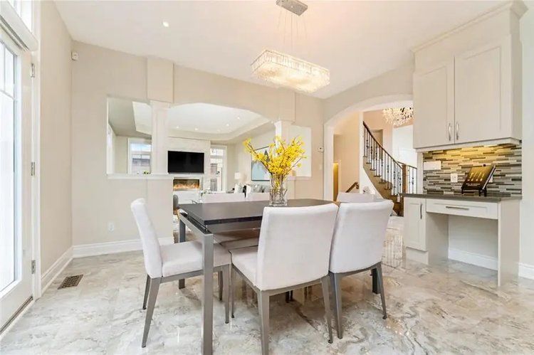 A dining room with a table and chairs in a house.