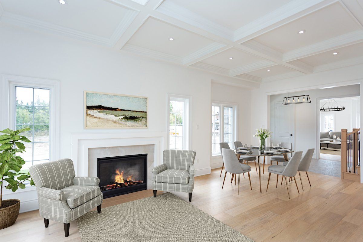 A living room with a fireplace , chairs , and a table.