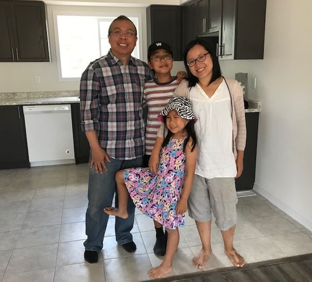 Family in a new kitchen built by Mikmada Homes for Habitat for Humanity