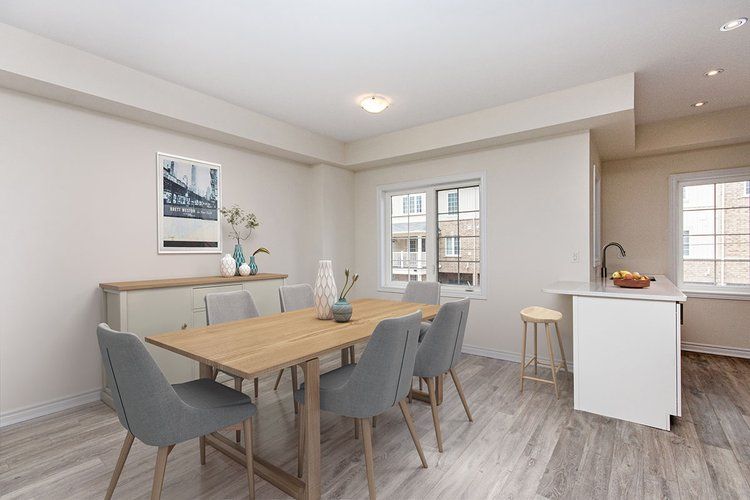 A dining room with a wooden table and chairs