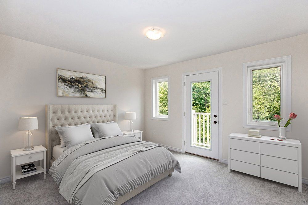 A bedroom with a bed , dresser , nightstand , and window.