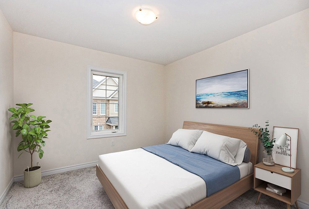 A bedroom with a bed , nightstand , and window.