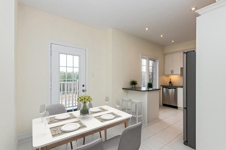 A dining room with a table and chairs in a house.