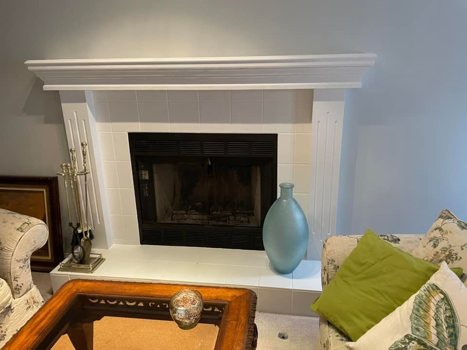 A living room with a fireplace and a coffee table