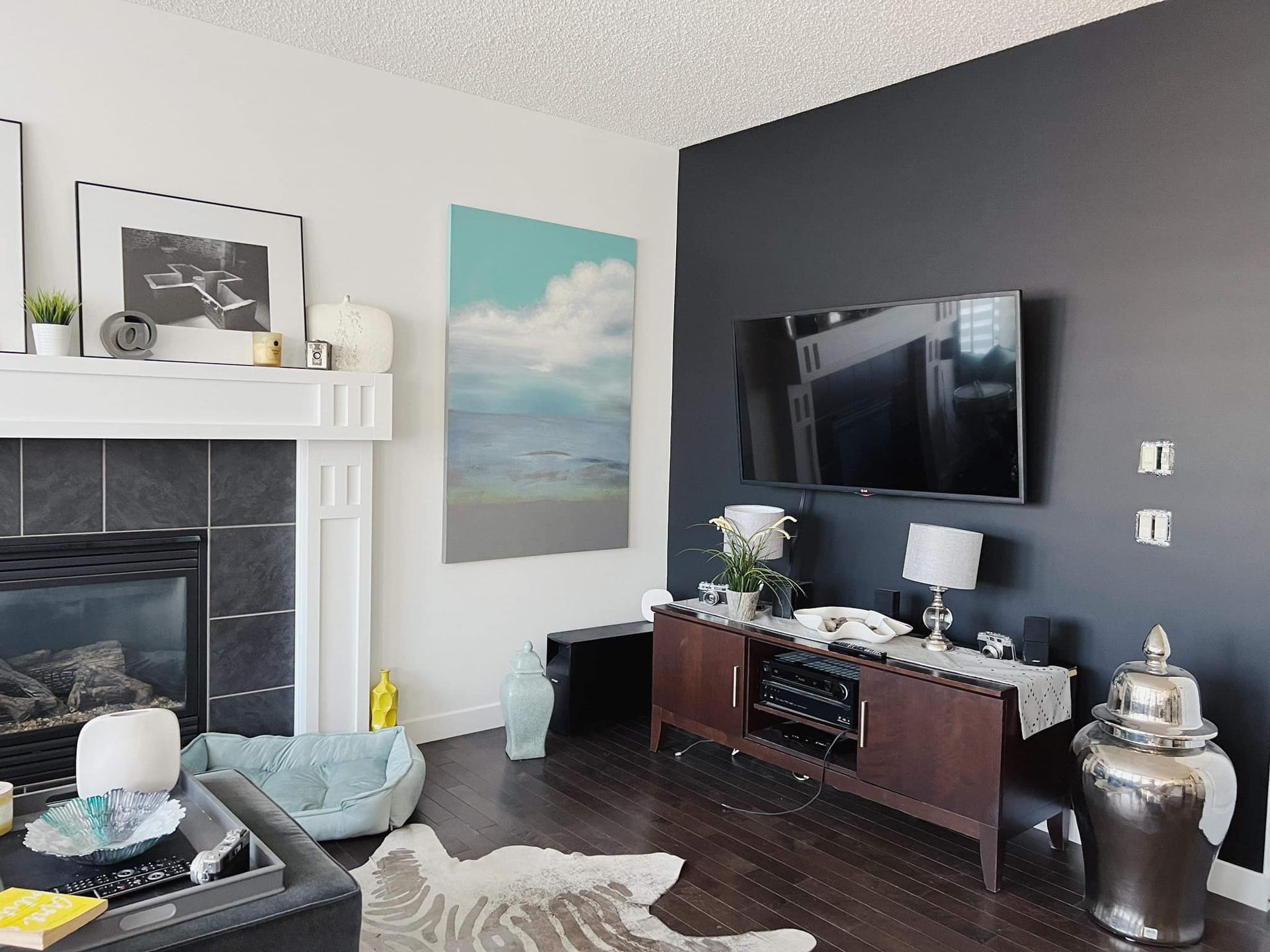 A living room with a fireplace and a flat screen tv