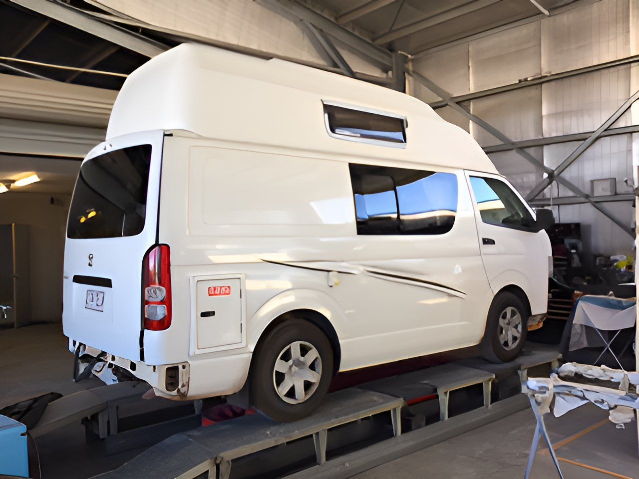 A White Van With A High Top Is Parked In A Garage — P & V Panel Works In Alice Springs, NT
