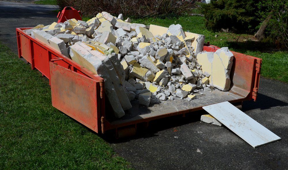 Red Dumpster With Rubble — Clinton, MO — Golden Valley Disposal LLC