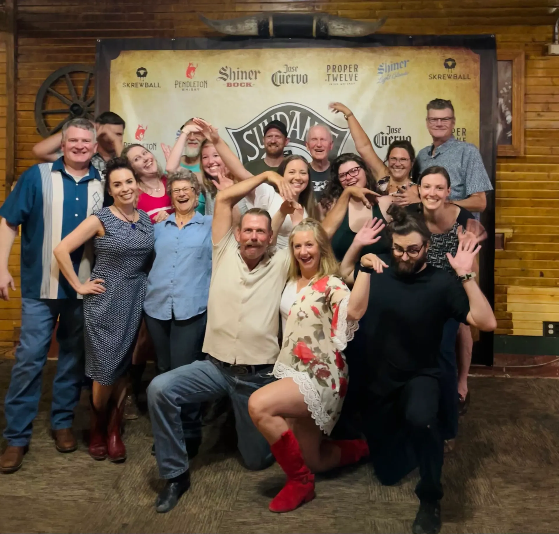 A group of people posing for a picture in front of a sign that says sigma