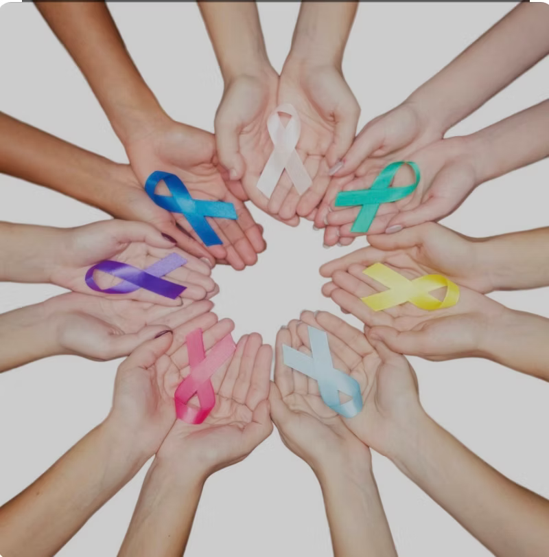 A group of people holding ribbons in their hands in a circle