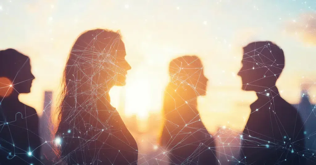 Silhouetted people standing in conversation against a bright sunset with connected network lines overlaying the scene