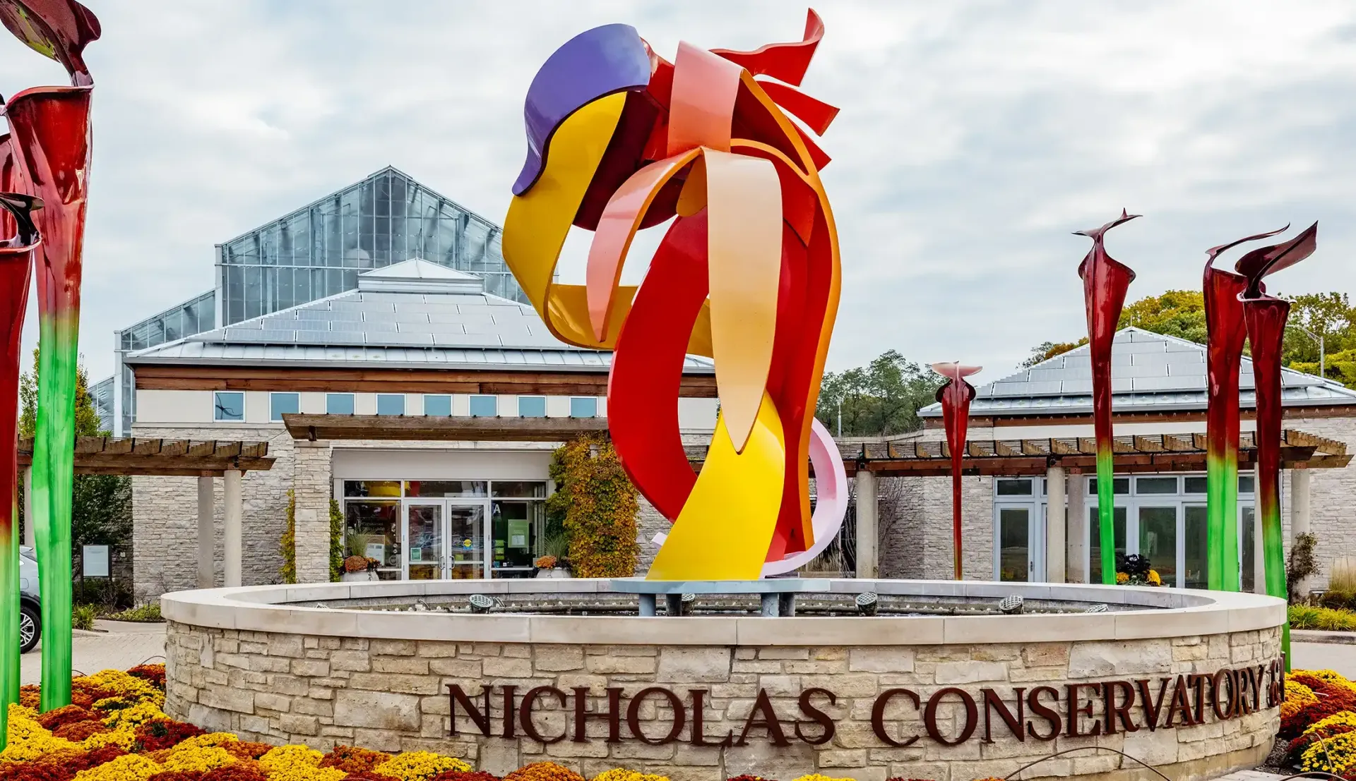 Nicholas Conservatory entrance with colorful abstract sculpture and modern glass building facade