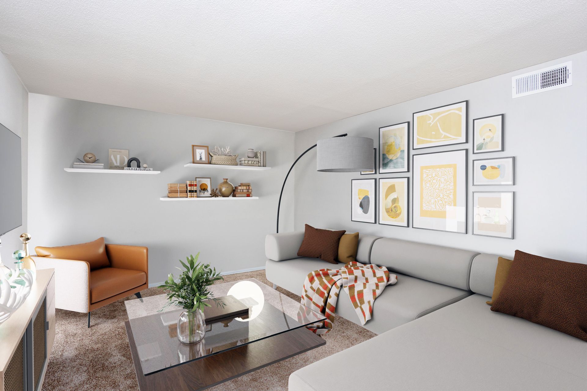 A modern living room with a gray sectional, brown armchair, glass coffee table, wall art gallery, and floating shelves.