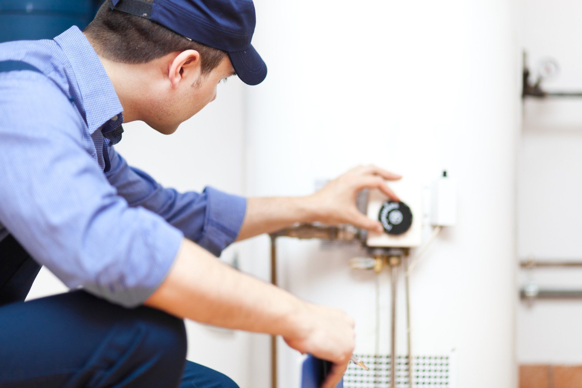 Man Checking Heater — Huntingburg, IN — RG Mechanical Contracting LLC