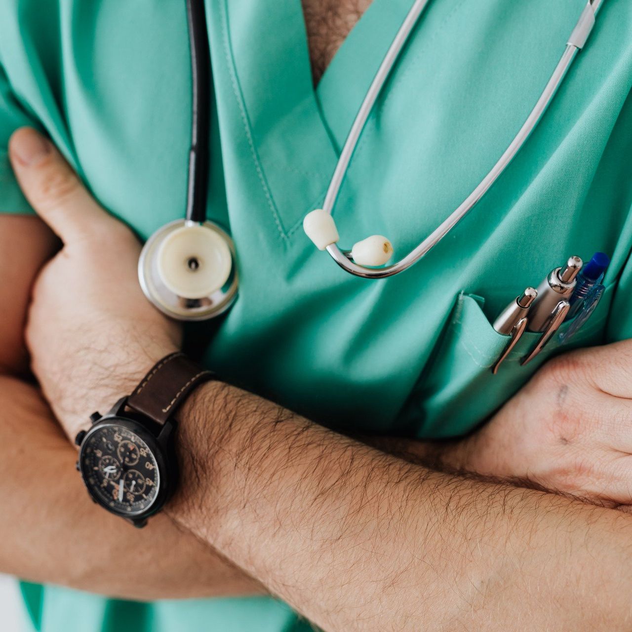 A doctor wearing a watch and a stethoscope around his neck