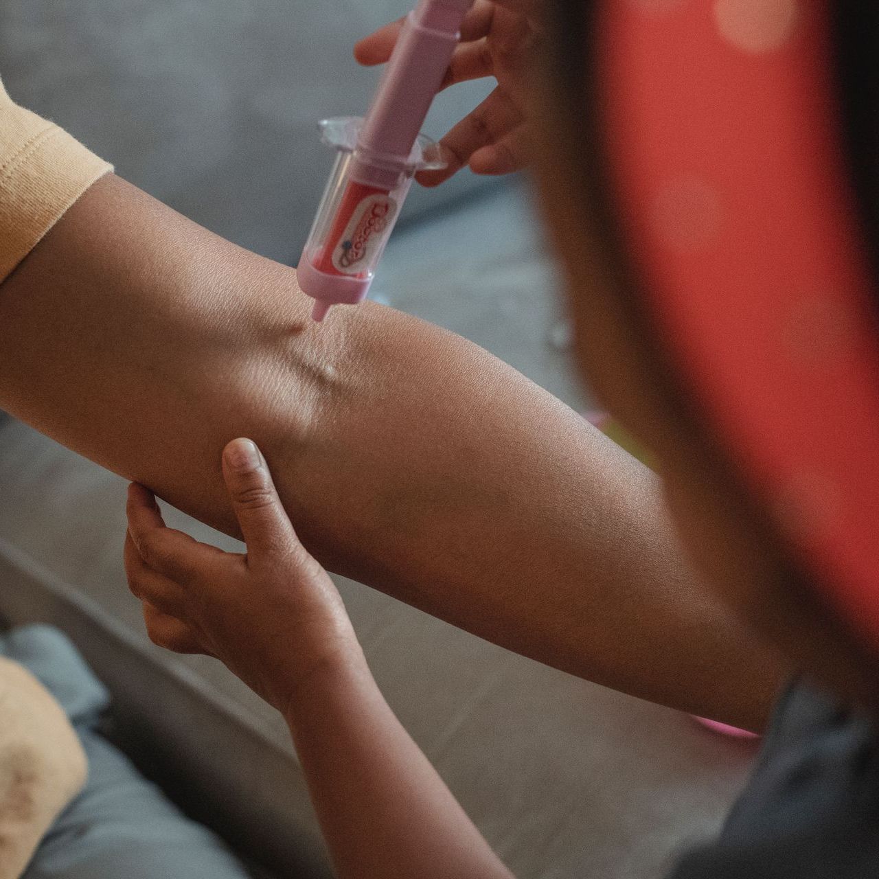 A person is getting an injection in their arm